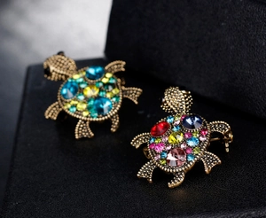 Macro shot of luxury tortoise brooches with vibrant multicolored crystal rhinestones