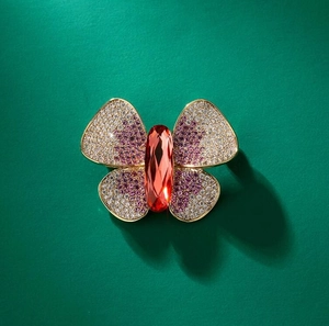 Elegant butterfly brooch with red gemstone and micro-paved crystal wings on gold frame