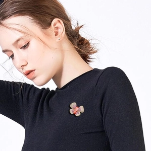 Elegant gradient purple crystal butterfly brooch pinned on a black minimalist sweater
