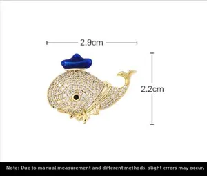 Detail of crystal whale brooch with blue enamel hat and 2.9cm width measurement