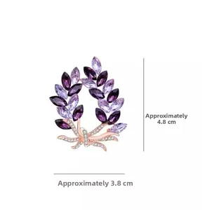 Detailed view of elegant purple crystal wreath brooch with rose gold finish and dimensions