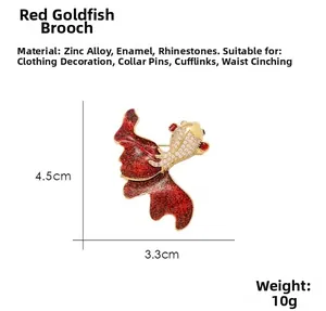 Close-up of red goldfish brooch with gold plating, white rhinestones and exact measurements