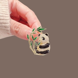 Exquisite gold panda brooch with sparkling white zircons and green bamboo branch accent