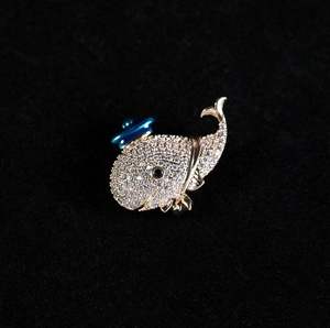 Sparkling crystal whale brooch with blue hat in gold-plated finish for women