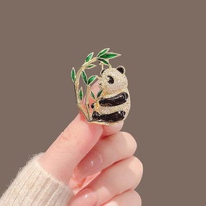 Elegant giant panda brooch with white rhinestones and green bamboo on golden base