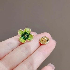 Elegante vergulde bloembroeche met groene kristalverlopen en klaverbladontwerp
