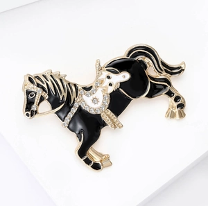 Detailed view of horse brooch with black oil finish and sparkling rhinestones