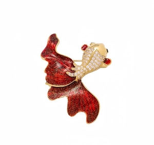 Close-up of elegant goldfish brooch with red enamel tail and white zircon inlays