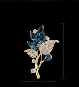 Detailed view of elegant orchid brooch measuring 5.9cm by 3.8cm with blue crystals