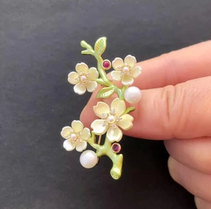 Detail of peach blossom brooch with yellow enamel, small diamonds and white pearls