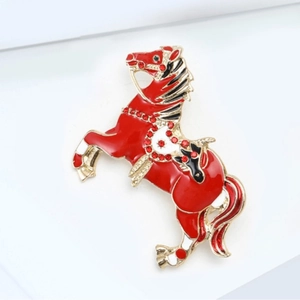 Running horse brooch in red enamel and sparkling rhinestones with gold metal plating