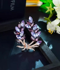 Macro shot of elegant purple leaf brooch with marquise crystals and rose gold accents
