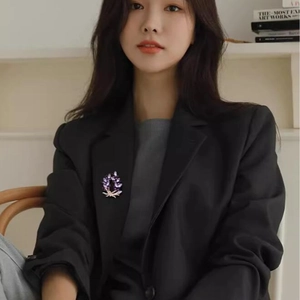 Elegant purple crystal wreath brooch in leaf shape on a black suit jacket for women