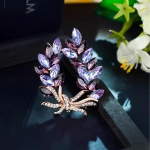 Elegant purple crystal laurel leaf brooch with rose gold bow and sparkling stones