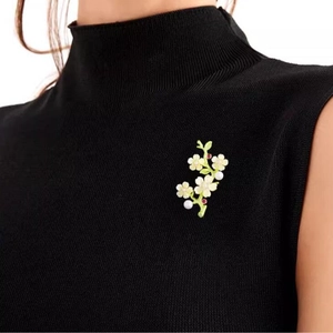 Elegant peach blossom branch brooch with pearls and crystals on black sweater