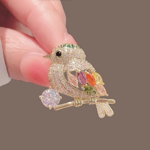 Detailed shot of a colorful magpie bird brooch with vibrant marquise cut gemstones
