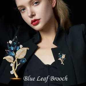 Elegant blue orchid leaf brooch in gold alloy with sapphire blue gems and zircons