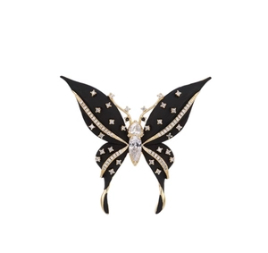 Detailed view of black butterfly brooch with matte finish and sparkling rhinestones