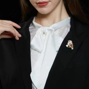 Elegant magpie bird brooch with colorful crystals on black suit lapel for women