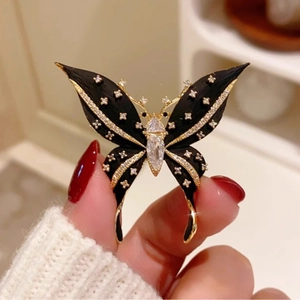 Elegant black butterfly brooch with crystals and gold-tone base for suit accessory