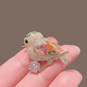 Golden magpie bird brooch with colorful gemstones and micro-pave diamond crystals