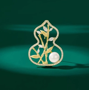 Elegant gold gourd brooch with bamboo leaf zircon inlay and white pearl detail