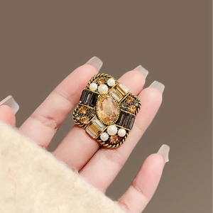 Vintage gold brooch with amber gemstones and pearls in a classic French court style