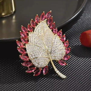 Elegant gold leaf brooch with white crystals and pink marquise stones for formal suits