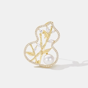 Elegant gold bamboo and gourd brooch featuring a lustrous pearl and sparkling gemstones