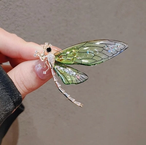 Elegant green and purple dragonfly brooch with cubic zirconia and translucent wings