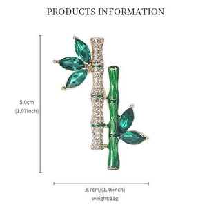 Bamboo brooch with green crystals and size markings measuring 5.0cm by 3.7cm height