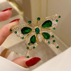 Elegant emerald butterfly brooch with golden frame and white crystals for luxury coats