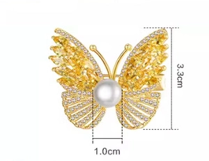 Detail view of butterfly brooch showing 3.3cm height and 1.0cm pearl width dimensions