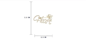 Detailed size view of golden Heart brooch with white crystals measuring 5.0 cm wide