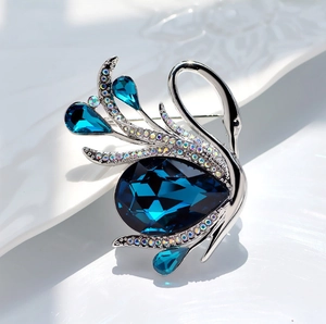 Elegant vintage swan brooch with deep blue pear-shaped rhinestone and silver alloy finish