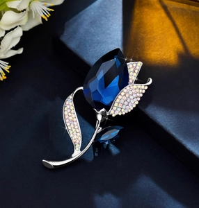 Macro shot of a tulip brooch featuring a dark blue pear-cut crystal and rainbow AB rhinestones