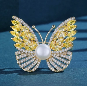 Elegant gold butterfly brooch with yellow marquise zircon, white diamonds and large pearl