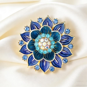 Elegant gold lotus flower brooch with blue gradient enamel and sparkling crystals