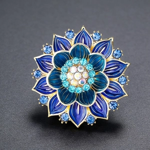 Luxurious blue enamel lotus flower brooch with sparkling crystals and golden metal base