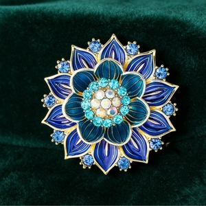 Luxurious blue enamel lotus flower brooch with gradient rhinestones on green velvet