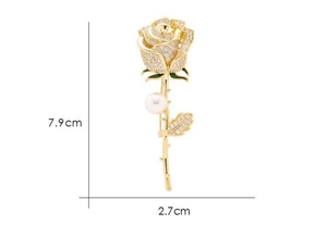 Détail de broche rose avec perle blanche et cristaux étincelants sur tige dorée