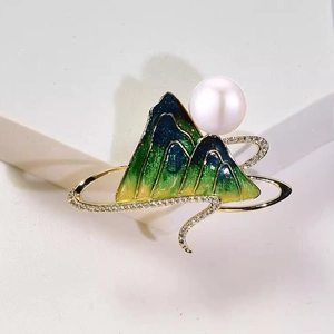 Green enamel mountain brooch with white pearl and sparkling crystals in gold plating
