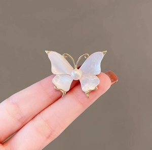 Vintage butterfly brooch with white shell wings and pearl center in gold plating