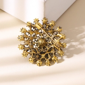 Vintage gold alloy dandelion brooch with intricate hollow metal design and secure pin back