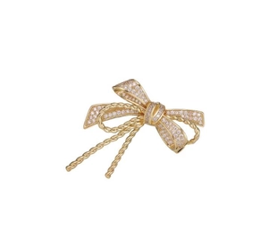 Elegant gold bow brooch with sparkling crystals and twisted rope texture on white background