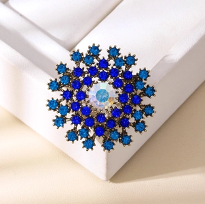Exquisite snowflake brooch with blue rhinestones and crystal on a bronze alloy base