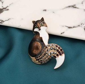 Detailed close-up of fox brooch with colorful enamel and sparkling rhinestones