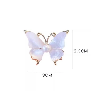 Vintage gold-edged butterfly brooch with iridescent wings and a central white pearl