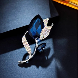 Elegant silver tulip brooch with a large deep blue crystal and sparkling accents