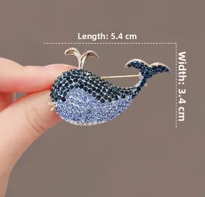 Close-up of blue whale brooch with sparkling crystals showing size of 5.4cm by 3.4cm